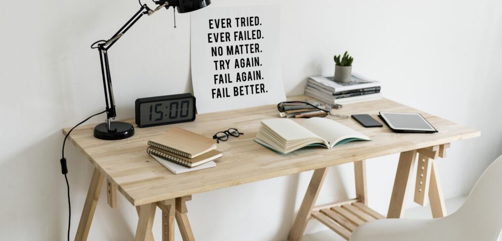 Desk set up with motivational poster on trying again